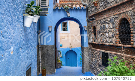 Chefchaouen town in Morocco, known as the Blue Pearl, famous for its striking blue color painted medina buildings and streets, creating a unique and magical atmosphere. Chefchaouen town in Morocco, known as the Blue Pearl, famous for its striking blue color painted medina buildings and streets, creating a unique and magical atmosphere. 107940732