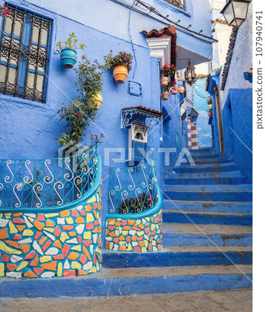 Chefchaouen town in Morocco, known as the Blue Pearl, famous for its striking blue color painted medina buildings and streets, creating a unique and magical atmosphere. Chefchaouen town in Morocco, known as the Blue Pearl, famous for its striking blue color painted medina buildings and streets, creating a unique and magical atmosphere. 107940741