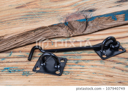 Black door hook on wood texture background 107940749