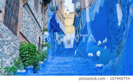 Chefchaouen town in Morocco, known as the Blue Pearl, famous for its striking blue color painted medina buildings and streets, creating a unique and magical atmosphere. Chefchaouen town in Morocco, known as the Blue Pearl, famous for its striking blue color painted medina buildings and streets, creating a unique and magical atmosphere. 107940754