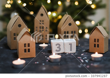 December 31 on white cubes calendar on a background with glowing garland. Christmas, winter, new year concept 107941287