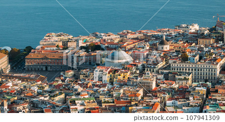 Naples, Italy. Top View Cityscape Skyline With Famous Landmarks And Part Of Gulf Of Naples With Ship In Sunny Day. Many Old Churches And Temples 107941309