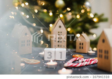 December 31 on white cubes calendar on a background with glowing garland. Christmas, winter, new year concept 107941310