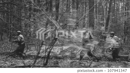 American Soldiers Of USA Infantry Of World War II Marching Running Run Along Forest In Autumn Spring Day. Group of soldiers 107941347