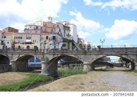 view of the town of Diamante, Cosenza, Calabria, Italy with famous bridge over the river that flows into the sea view of the town of Diamante, Cosenza, Calabria, Italy with famous bridge over the river that flows into the sea 107941488