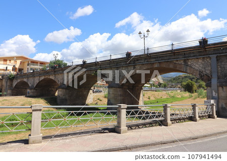 view of the town of Diamante, Cosenza, Calabria, Italy with famous bridge over the river that flows into the sea view of the town of Diamante, Cosenza, Calabria, Italy with famous bridge over the river that flows into the sea 107941494