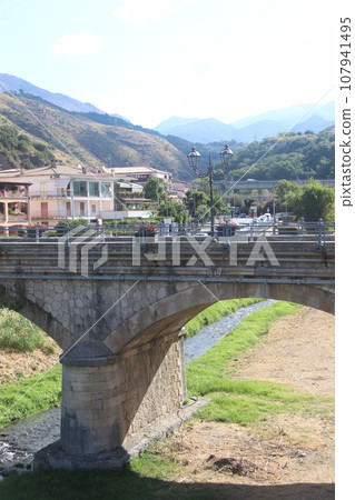 view of the town of Diamante, Cosenza, Calabria, Italy with famous bridge over the river that flows into the sea 107941495