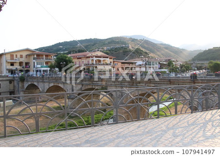view of the town of Diamante, Cosenza, Calabria, Italy with famous bridge over the river that flows into the sea view of the town of Diamante, Cosenza, Calabria, Italy with famous bridge over the river that flows into the sea 107941497