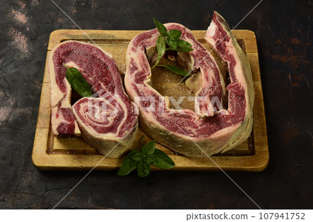 Roasted beef ribs ready to cook, Traditional Argentine cuisine, Patagonia, Argentina. 107941752