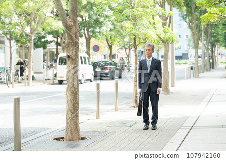 Walking senior man business Walking senior man business 107942160