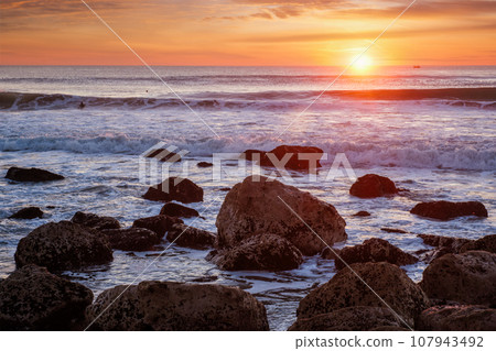 Atlantic ocean sunset with waves and rocks at Costa da Caparica, Portugal Atlantic ocean sunset with waves and rocks at Costa da Caparica, Portugal 107943492