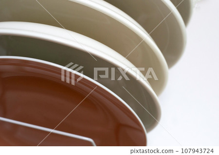 Clean plates in dish drying metal rack Clean plates in dish drying metal rack 107943724