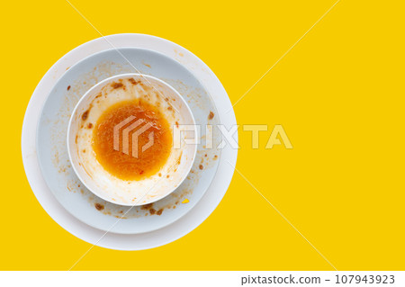 Dirty dishes on yellow background. Top view Dirty dishes on yellow background. Top view 107943923
