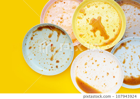 Dirty dishes on yellow background. Top view 107943924