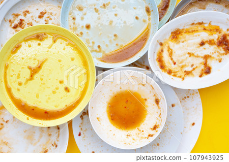 Dirty dishes on yellow background. Top view Dirty dishes on yellow background. Top view 107943925