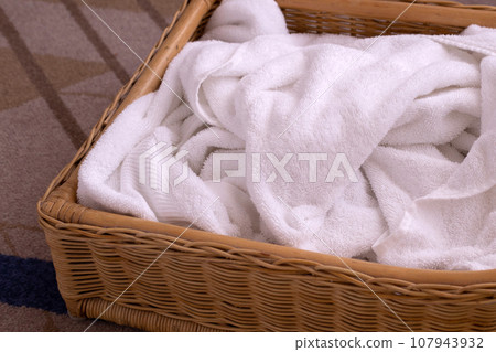 Used towel in a wicker basket 107943932
