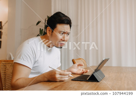 Serious and crying face of man working in the cafe. Serious and crying face of man working in the cafe. 107944199