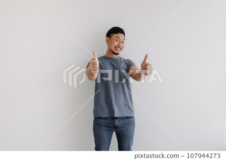 Happy smile asian man showing two thumbs up for good stand isolated on white 107944273