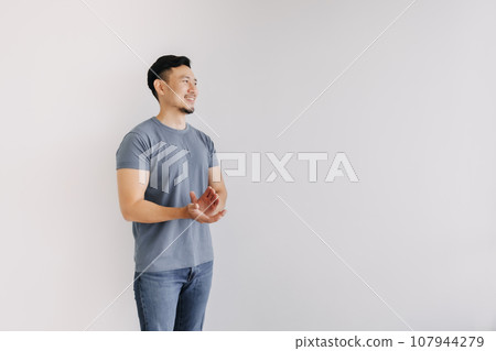Happy man in blue t-shirt and jeans clapping hands stand isolated on white. Happy man in blue t-shirt and jeans clapping hands stand isolated on white. 107944279