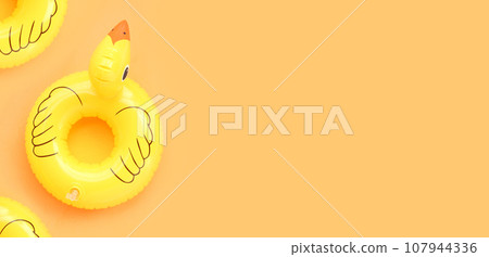 Inflatable of yellow duck on yellow background. Summer background concept Inflatable of yellow duck on yellow background. Summer background concept 107944336