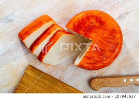 Image of goat cheese with pepper on wooden desk 107945637