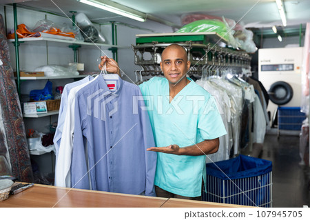 Portrait of male worker of dry-cleaning facility Portrait of male worker of dry-cleaning facility 107945705