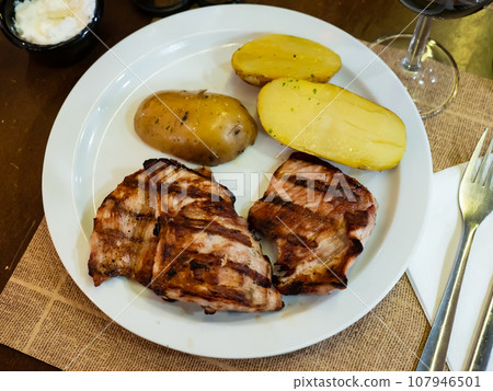 Grilled pork pieces with boiled half potatoes served in a plate Grilled pork pieces with boiled half potatoes served in a plate 107946501