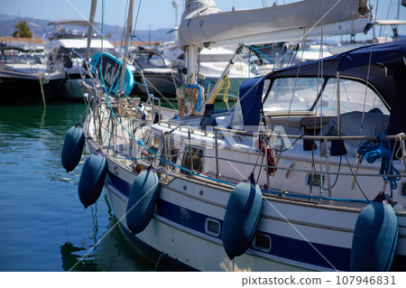Luxury yachts and motor boats in marina at sunset 107946831