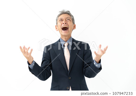 A senior man in a suit who is excited and happy 107947233