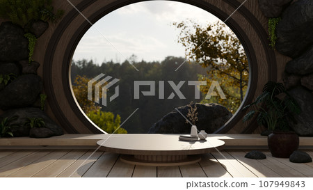 A product pedestal on a wood coffee table in front of a round window with a mountain view. 107949843
