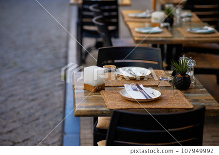 Table set for an event party or wedding reception in a restaurant. Table set for an event party or wedding reception in a restaurant. 107949992