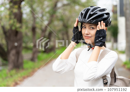 young woman wearing a cycling helmet young woman wearing a cycling helmet 107951192