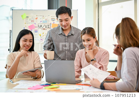 A group of Asian tech developers is in the meeting, discussing work, planning and brainstorming 107951213