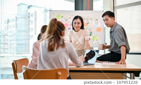 A tech developer team is in the meeting, discussing, brainstorming on a new mobile app 107951220