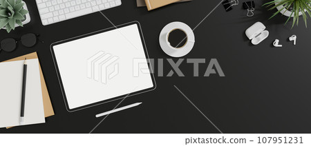 Top view of a stylish black office desk with digital tablet mockup and decor. 107951231