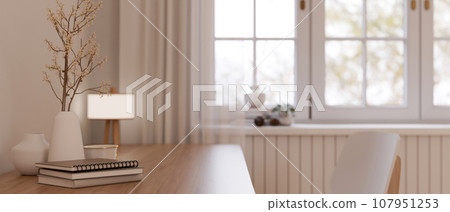 A workspace with books, ceramic vases, and table lamp in a beautiful minimalist room. A workspace with books, ceramic vases, and table lamp in a beautiful minimalist room. 107951253