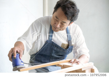 Man using sander DIY at home Man using sander DIY at home 107952006