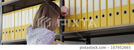 Exhausted woman fails finding right materials for research Exhausted woman fails finding right materials for research 107952665
