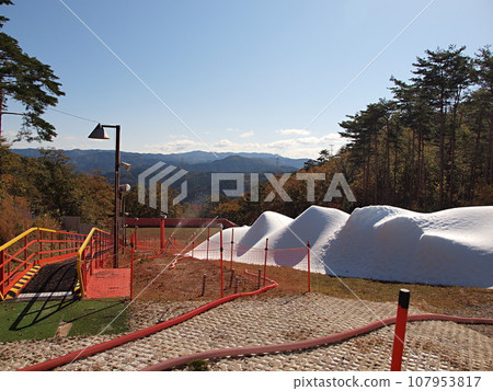 Creating a ski slope using a snow machine 107953817
