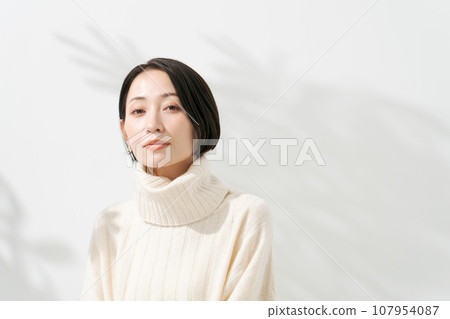 Portrait of a woman wearing knitwear 107954087