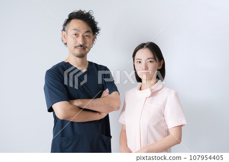 Doctor and nurse in white coat looking at camera Doctor and nurse in white coat looking at camera 107954405