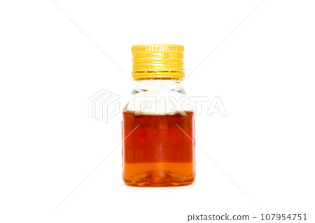 Honey bottle on white background with selective focus 107954751
