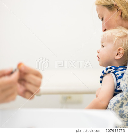 child beeing vaccinated by pediatrician in presence of his mother. Preventive vaccination against Diphtheria, whooping cough, tetanus, hepatitis, haemophilus influenzae, pneumococcus, poliomyelitis. child beeing vaccinated by pediatrician in presence of his mother. Preventive vaccination against Diphtheria, whooping cough, tetanus, hepatitis, haemophilus influenzae, pneumococcus, poliomyelitis. 107955753