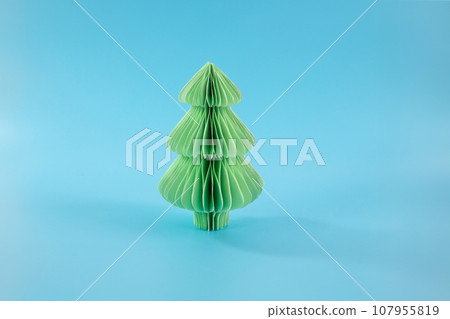 a folded paper christmas tree on a blue background, diy a folded paper christmas tree on a blue background, diy 107955819