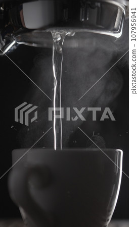 shot rinsing coffee machine with bottomless portafilter closeup 107956941