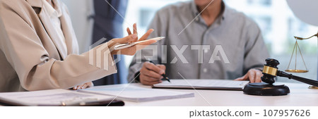 Businesswoman explain data and ask about contract while senior lawyer pointing on contract for sign 107957626