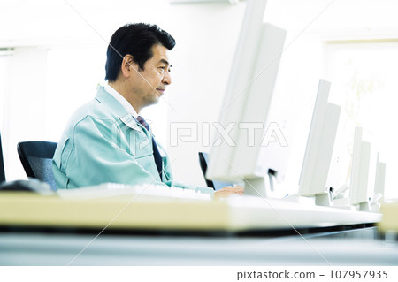 Middle-aged male businessman wearing work clothes working in the office Middle-aged male businessman wearing work clothes working in the office 107957935