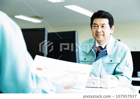 Middle-aged male businessman wearing work clothes working in the office Middle-aged male businessman wearing work clothes working in the office 107957937