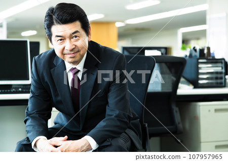 Middle-aged male manager working in the office Middle-aged male manager working in the office 107957965