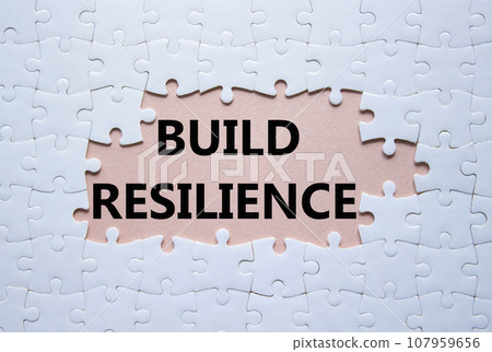 Build resilience symbol. White puzzle with words Build resilience. Beautiful pink background. Business and Build resilience concept. Copy space. 107959656